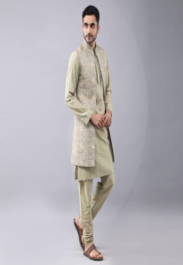 Printed front open bundi jacket with sequince embrodery. It is paired with zari work kurta and churidaar pyjama.